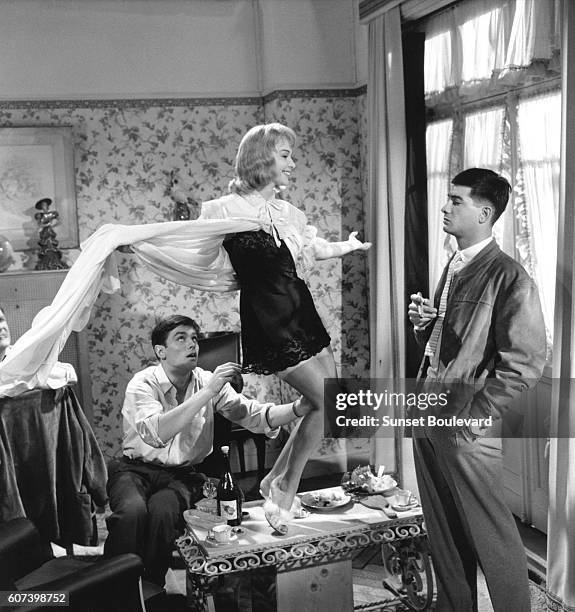 French actors Alain Delon, Francoise Arnoul, and Jean-Claude Brialy on the set of Le Chemin des Ecoliers, directed by Michel Boisrond.