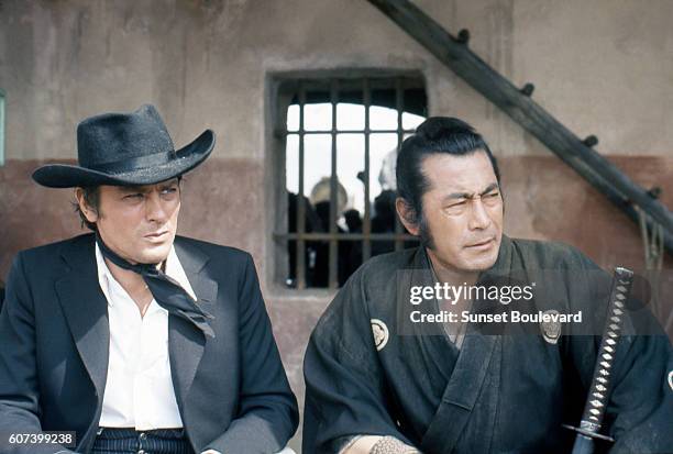 French actor Alain Delon and Japanese actor Toshiro Mifune on the set of Soleil Rouge , directed by British Terence Young.