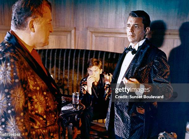 German actor Reinhard Kolldehoff, Austrian actor Helmut Berger, and British actor Dirk Bogarde on the set of La Caduta Degli Dei , written and...