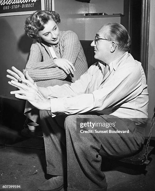 American actress Barbara Stanwyck and director Fritz Lang on the set of Lang's movie Clash by Night.