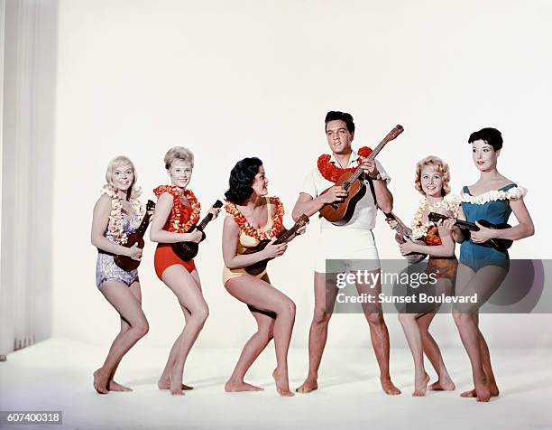 American singer, actor Elvis Presley surrounded by actresses Jenny Maxwell, Pamela Austin, Joan Blackman, Darlene Tompkins, and Christian Kay on the...