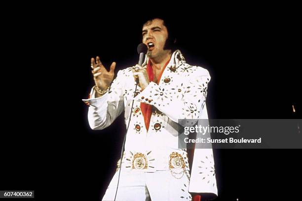 American singer Elvis Presley performing on tour.