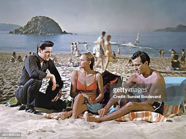 American singer, actor Elvis Presley with Swiss actress Ursula Andress and Argentine actor Alejandro Rey in Fun in Acapulco directed by American...