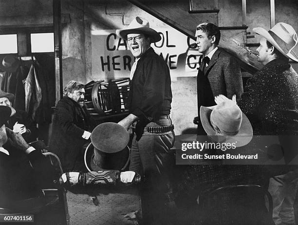 American actors John Wayne and James Stewart on the set of The Man Who Shot Liberty Valance directed and produced by John Ford.