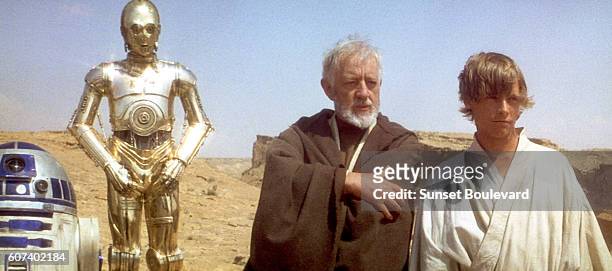 British actors Anthony Daniels, Alec Guinness and American Mark Hamill on the set of Star Wars: Episode IV - A New Hope written, directed and...