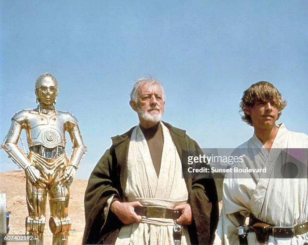 British actors Anthony Daniels, Alec Guinness and American Mark Hamill on the set of Star Wars: Episode IV - A New Hope written, directed and...