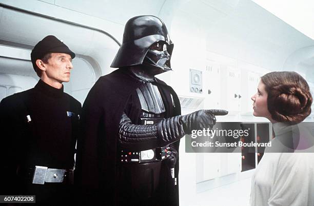 British actor David Prowse and American actress Carrie Fisher on the set of Star Wars: Episode IV - A New Hope written, directed and produced by...