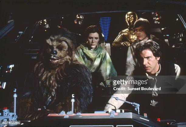 British actors Peter Mayhew, Anthony Daniels, American Carrie Fisher and Harrison Ford on the set of Star Wars: Episode VI - Return of the Jedi...