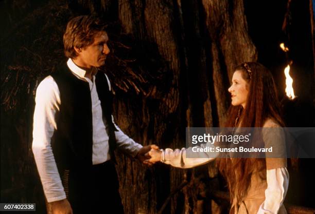 American actors Harrison Ford and Carrie Fisher on the set of Star Wars: Episode VI - Return of the Jedi directed by Welsh Richard Marquand.