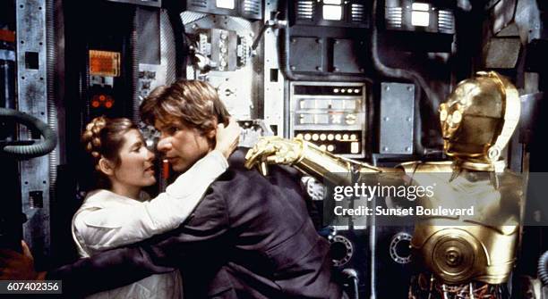 American actors Carrie Fisher, Harrison Ford and British Anthony Daniels on the set of Star Wars: Episode V - The Empire Strikes Back directed by...