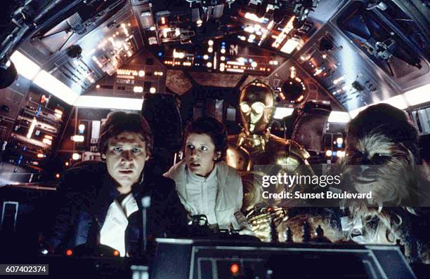 American actors Harrison Ford, Carrie Fisher, British actors Anthony Daniels and Peter Mayhew on the set of Star Wars: Episode V - The Empire Strikes...