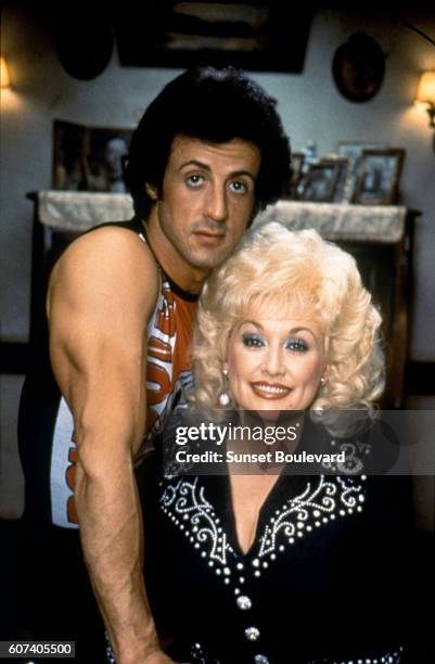 American actor and screenwriter Sylvester Stallone and singer, songwriter and actress Dolly Parton on the set of Rhinestone directed by Bob Clark.