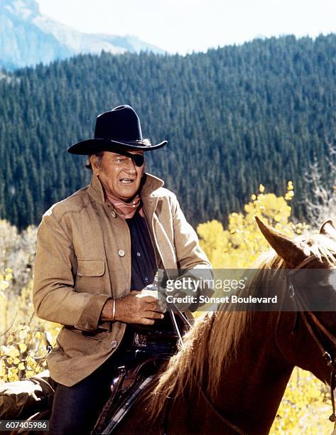 American actor John Wayne on the set of True Grit, based on the novel by Charles Portis, and directed by Henry Hathaway.