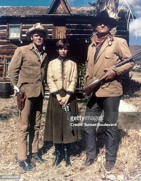 American actors Kim Darby, Glen Campbell and John Wayne on the set of True Grit, based on the novel by Charles Portis, and directed by Henry Hathaway.