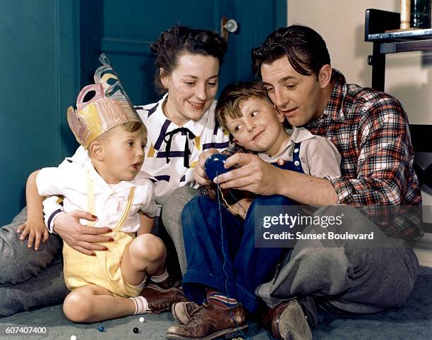 American actor Robert Mitchum and his wife Dorothy Spence and their two sons, Christopher and James .