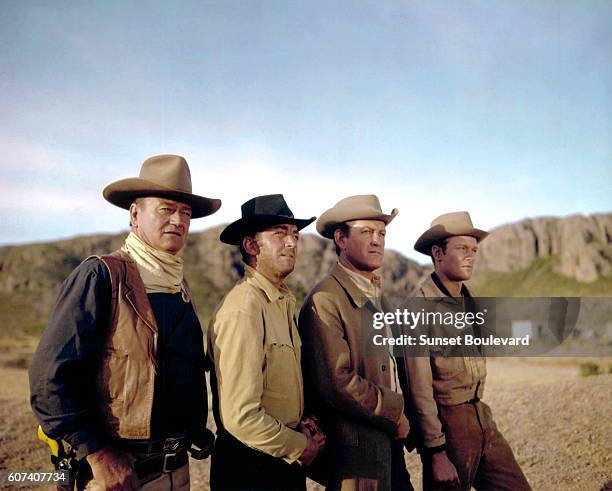 American actors John Wayne, Dean Martin, Earl Holliman and British Michael Anderson Jr. On the set of The Sons of Katie Elder, directed by Henry...