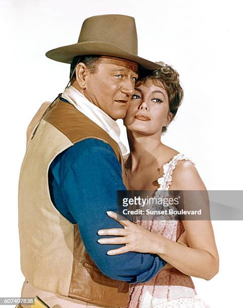 American actors John Wayne and Charlene Holt on the set of El Dorado, based on the novel by Harry Brown and directed by Howard Hawks.