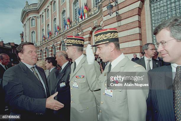 Gerhard Schroeder greets Helmut Willmann, commander of Eurocorps.