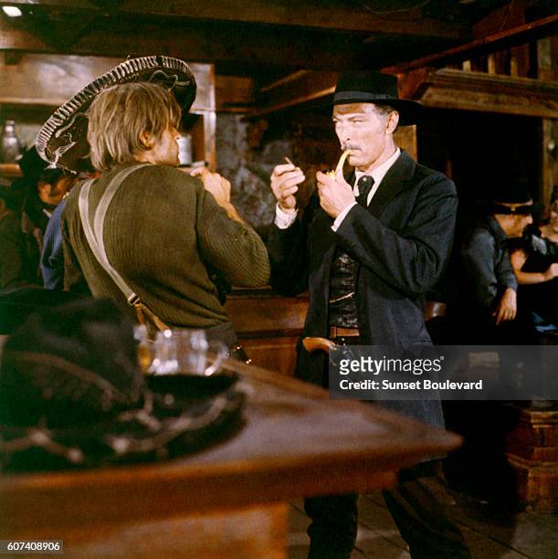 German actor Klaus Kinski and American actor Lee Van Cleef on the set of For a Few Dollars More , written and directed by Italian Sergio Leone.