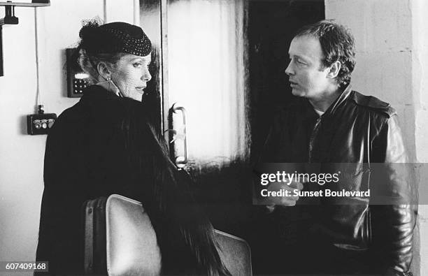 French actress Catherine Deneuve with British director Tony Scott on the set of his movie The Hunger.