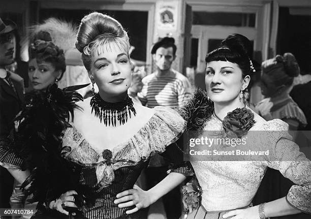 French actresses Simone Signoret and Dominique Davray on the set of Casque d'Or, written and directed by Jacques Becker.