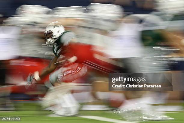 Running back Paul Harris of the Hawaii Warriors rushes the football against the Arizona Wildcats during the third quarter of the college football...