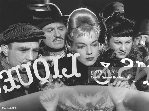 French actors Claude Dauphin, Simone Signoret and Dominique Davray on the set of Casque d'Or, written and directed by Jacques Becker.