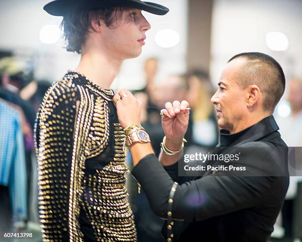 Celebrity Fashion Designer Julien Macdonald pictured hand stitching backstage for his Spring/Summer 2017 Collection Runway Show during London Fashion...