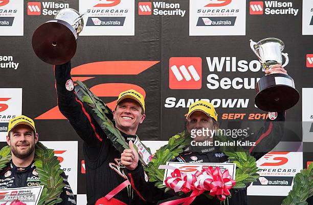 Garth Tander and Warren Luff drivers of the Holden Racing Team Holden Commodore VF celebrate on the podium after winning the Sandown 500 at Sandown...