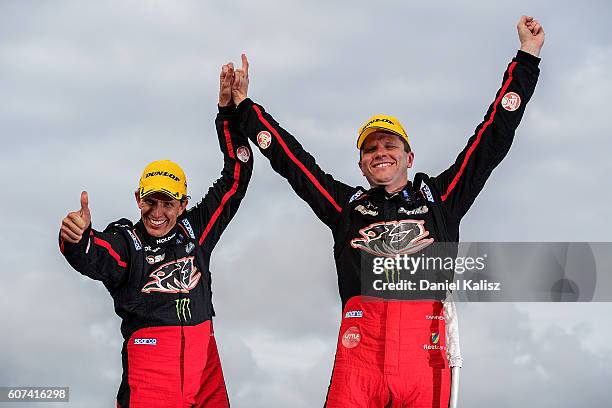 Warren Luff and Garth Tander drivers of the Holden Racing Team Holden Commodore VF celebrate in parc ferme after winning the Sandown 500 at Sandown...