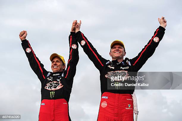 Warren Luff and Garth Tander drivers of the Holden Racing Team Holden Commodore VF celebrate in parc ferme after winning the Sandown 500 at Sandown...