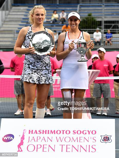 Japan Women's Open tennis singles winner Christina McHale of the US poses while holding her trophy beside runner-up Katerina Siniakova of Czech...