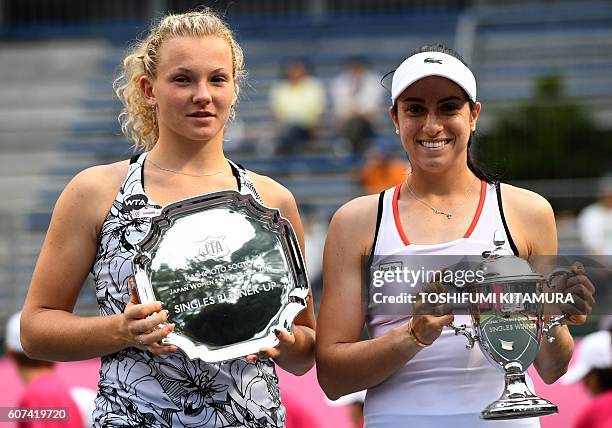 Japan Women's Open tennis singles winner Christina McHale of the US poses while holding her trophy beside runner-up Katerina Siniakova of Czech...