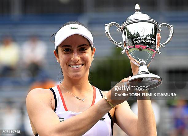 Japan Women's Open tennis singles winner Christina McHale of the US poses while holding her trophy during the awarding ceremony in Tokyo on September...