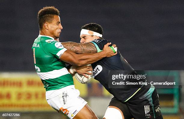 Josh Matavesi of Ospreys under pressure from David Odiete of Benetton Treviso during the Guinness PRO12 Round 3 match between Ospreys and Benetton...