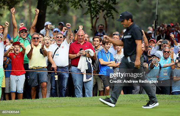 Spectators celebrate after Francesco Molinari holes an eagle putt on the 1st hole during the fourth round of the Italian Open at Golf Club Milano -...