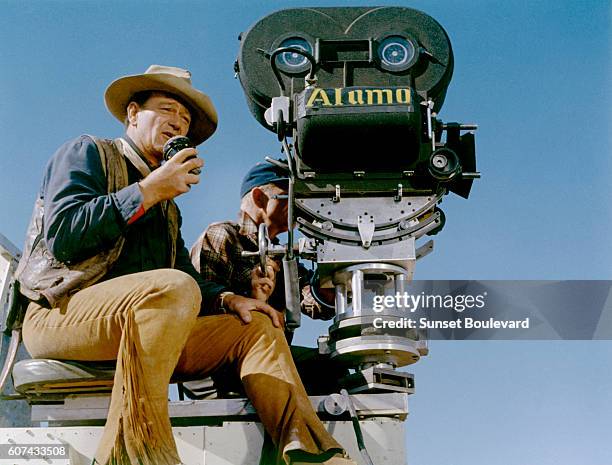 American actor and director John Wayne on the set of his movie The Alamo.