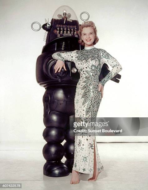American actress Anne Francis and Robby, the Robot, on the set of Forbidden Planet, directed by Fred M. Wilcox.