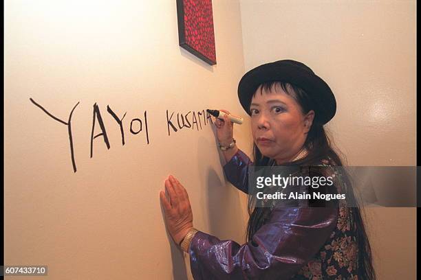 On April 3 2001, Yayoi Kusama signs a wall.