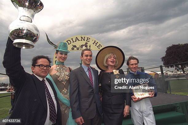 Billionaire art dealer Alec Wildenstein raises the trophy after his horse, Aquarelliste, won the Prix de Diane at Chantilly Racecourse, Chantilly,...