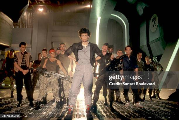 American actress Sigourney Weaver, surrounded by actors Paul Reiser, Michael Biehn, Jenette Goldstein and Lance Henriksen, on the set of Alien,...