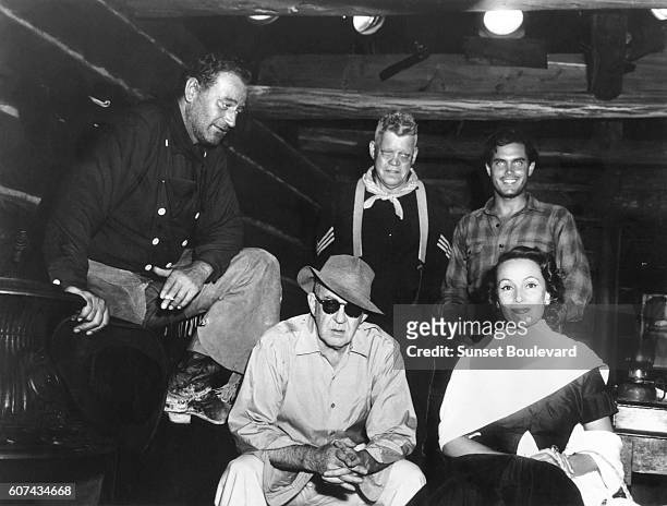 American actors John Wayne, Jack Pennick, Jeffrey Hunter and Mexican actress Dolores Del Rio with director John Ford on the set of his movie The...
