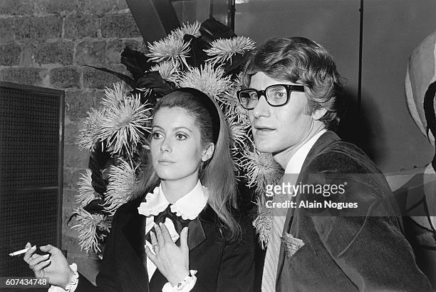 French actress Catherine Deneuve stands with fashion designer Yves Saint Laurent, for whom she sometimes models.