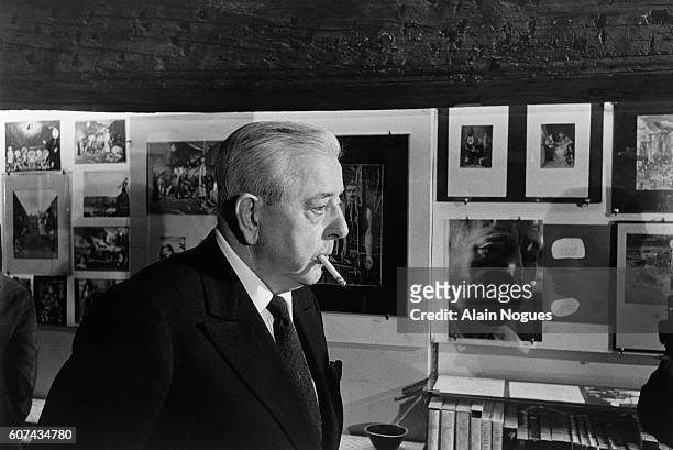 French poet and screenwriter Jacques Prevert visits an exhibition of his collages.