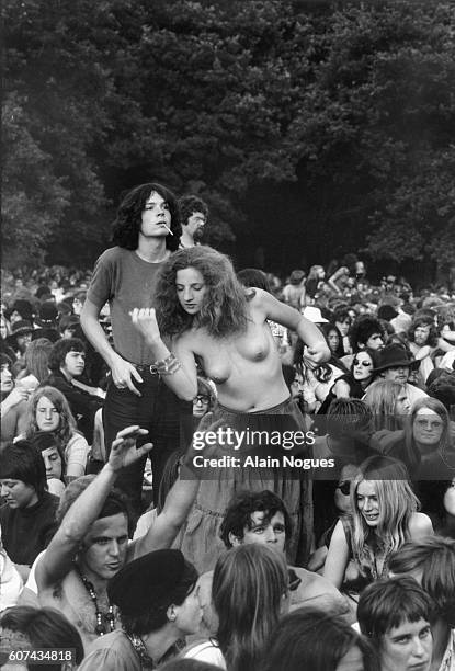 Young woman in the audience dances topless during the 1970 Rotterdam Pop Festival in Rotterdam, Holland.