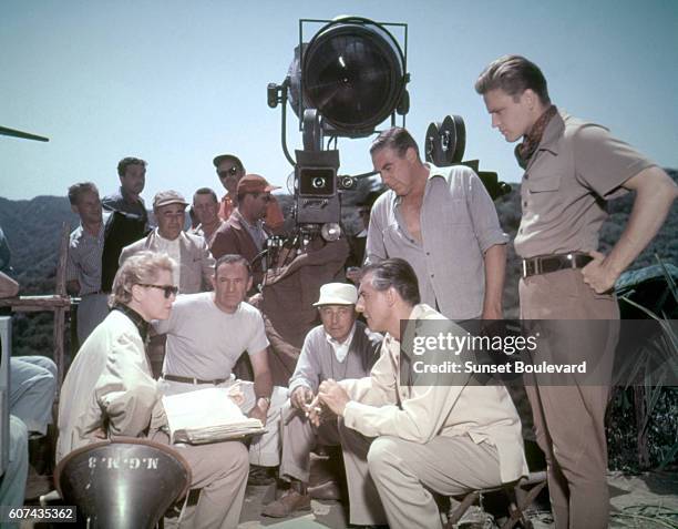 Grace Kelly, Paul Douglas, Stewart Granger and John Ericson on the set of 'Green Fire', directed by Andrew Marton, 1954.