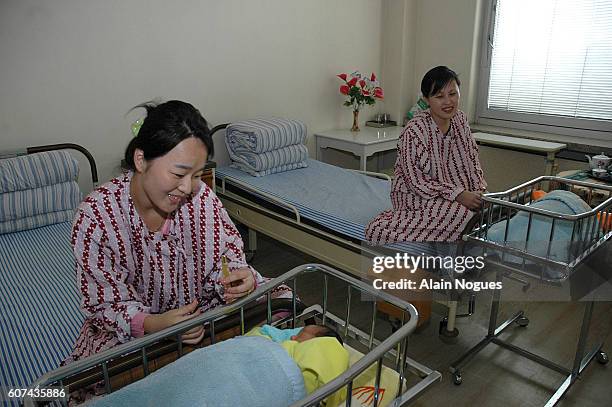 RAdiant young mothers in the modern maternity ward of the Pyongyang hospital where fees are covered by the state.