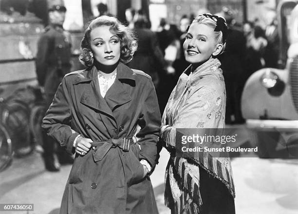 German actress and singer Marlene Dietrich and American actress Jean Arthur on the set of A Foreign Affair, written and directed by Billy Wilder.