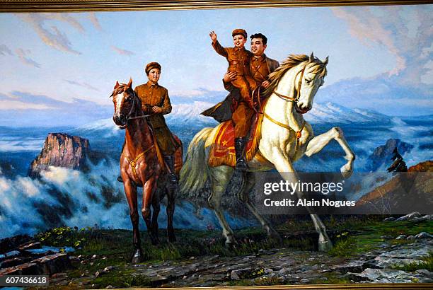 Painting on display at SEK animation studios depicting Kim Jong-il as a child, in the arms of his father Kim il-Sung, on a white stallion. Behind the...