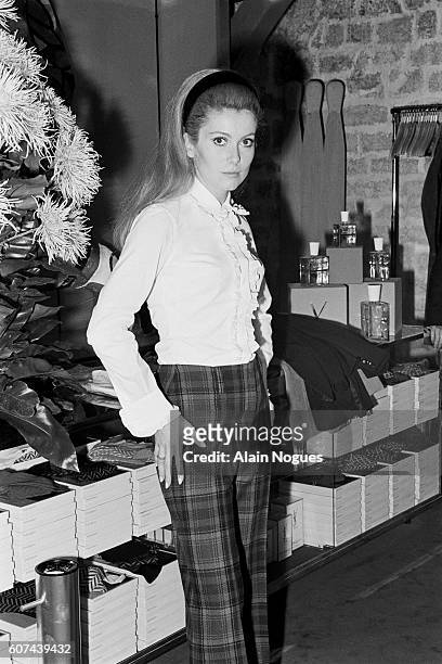 French actress Catherine Deneuve models an outfit for French fashion designer Yves Saint Laurent.